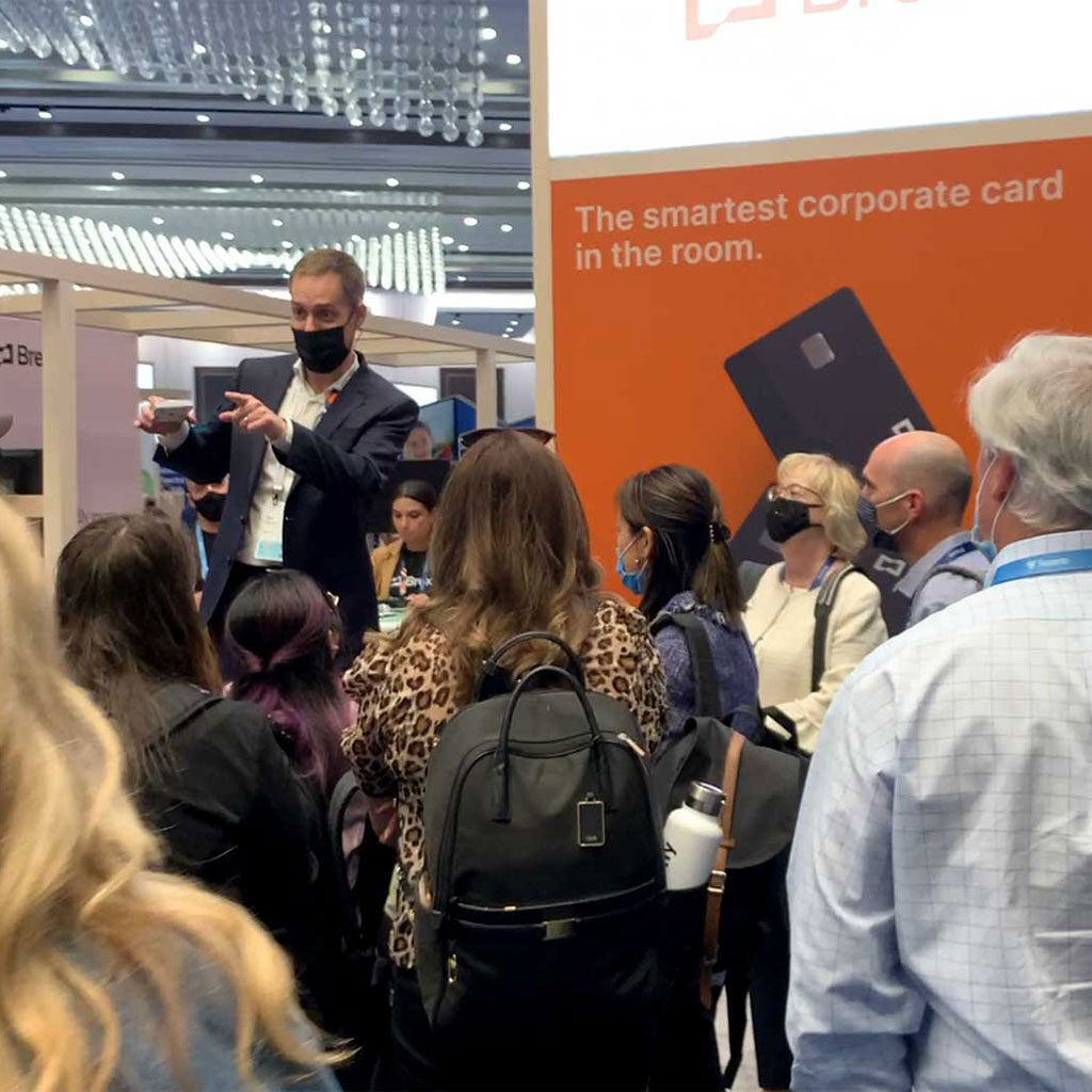 Trade show magic draws a crowd, even while wearing a mask. 
