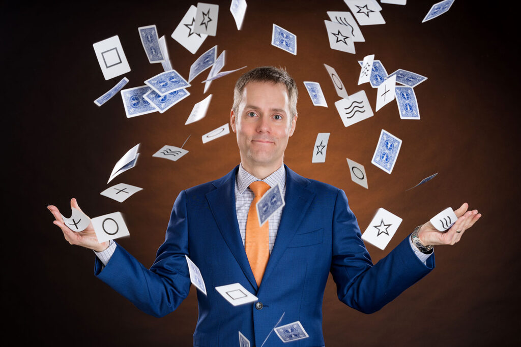 Corporate Magician Joe Skilton with an explosion of ESP cards