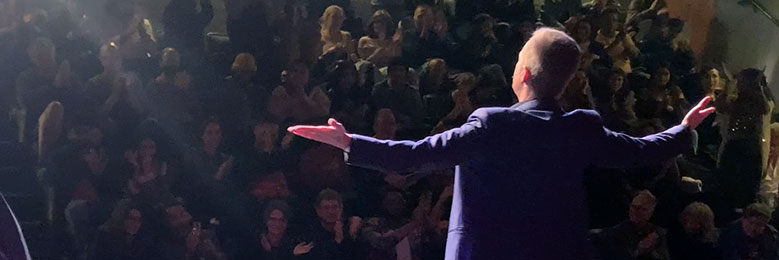 People applauding at the end of a corporate show.