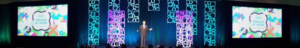 Mentalist Joe Skilton delivers a keynote on stage.