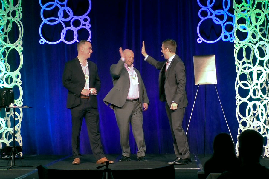 Joe Skilton gives a high-five to an employee during his mentalist keynote.