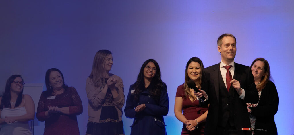 Corporate event mentalist Joe Skilton on stage with volunteers.