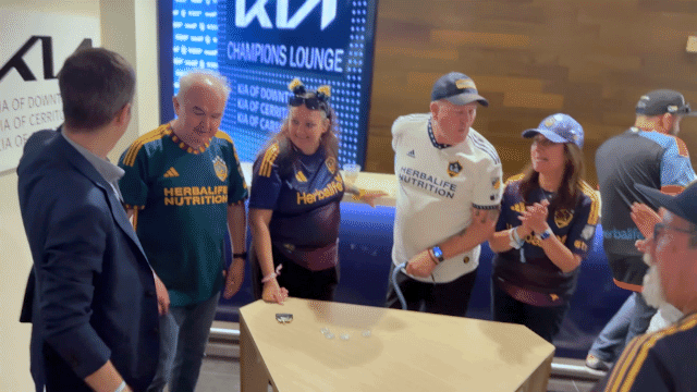 LA Galaxy VIPs applaud mentalist Joe Skilton.
