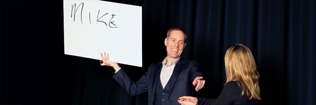Mentalist Joe Skilton reveals a name on stage at the HP 2026 annual sales kickoff.