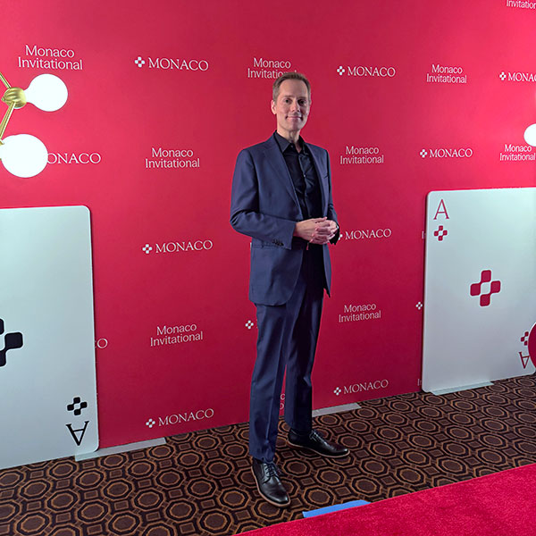 Mentalist Joe Skilton at the Monaco Invitational step & repeat wall