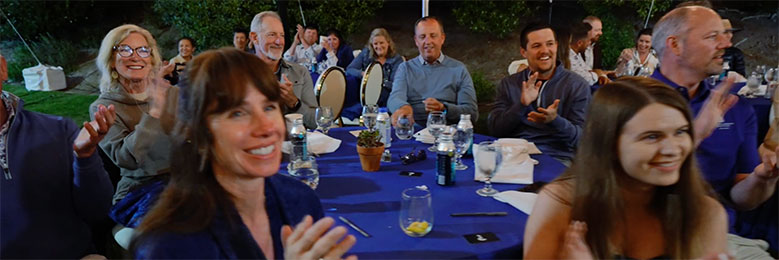 Executives clap during the mentalism show.